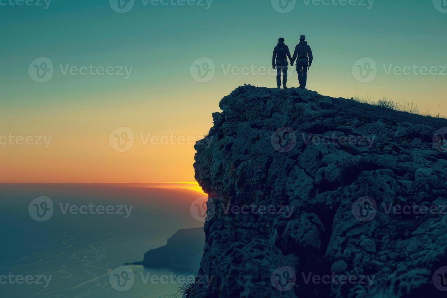 AI generated Climbers Silhouetted Against Sunset on Ocean Cliff. Two rock climbers, silhouetted by the setting sun, scale a steep cliff overlooking the ocean. photo