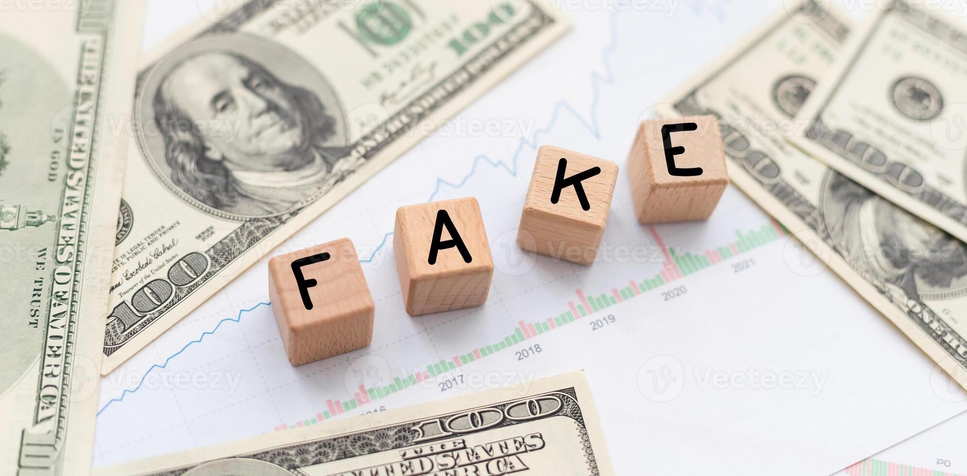 Fake news symbol. Wooden blocks with concept words Fake news on beautiful background from dollar bills. Business media and fake news concept. Copy space. photo
