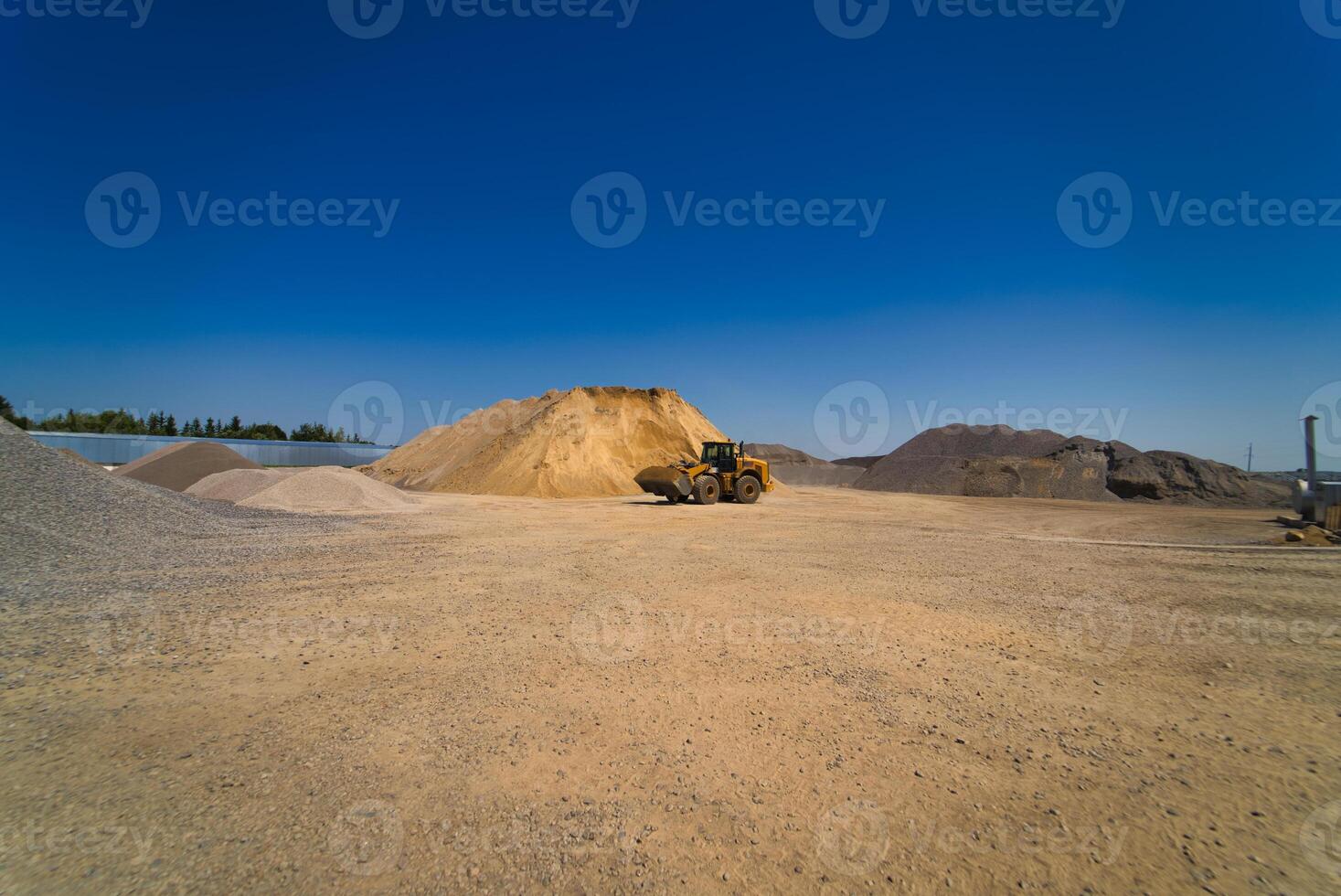 Quarry aggregate with heavy duty machinery. Construction industry. Horizontal photo