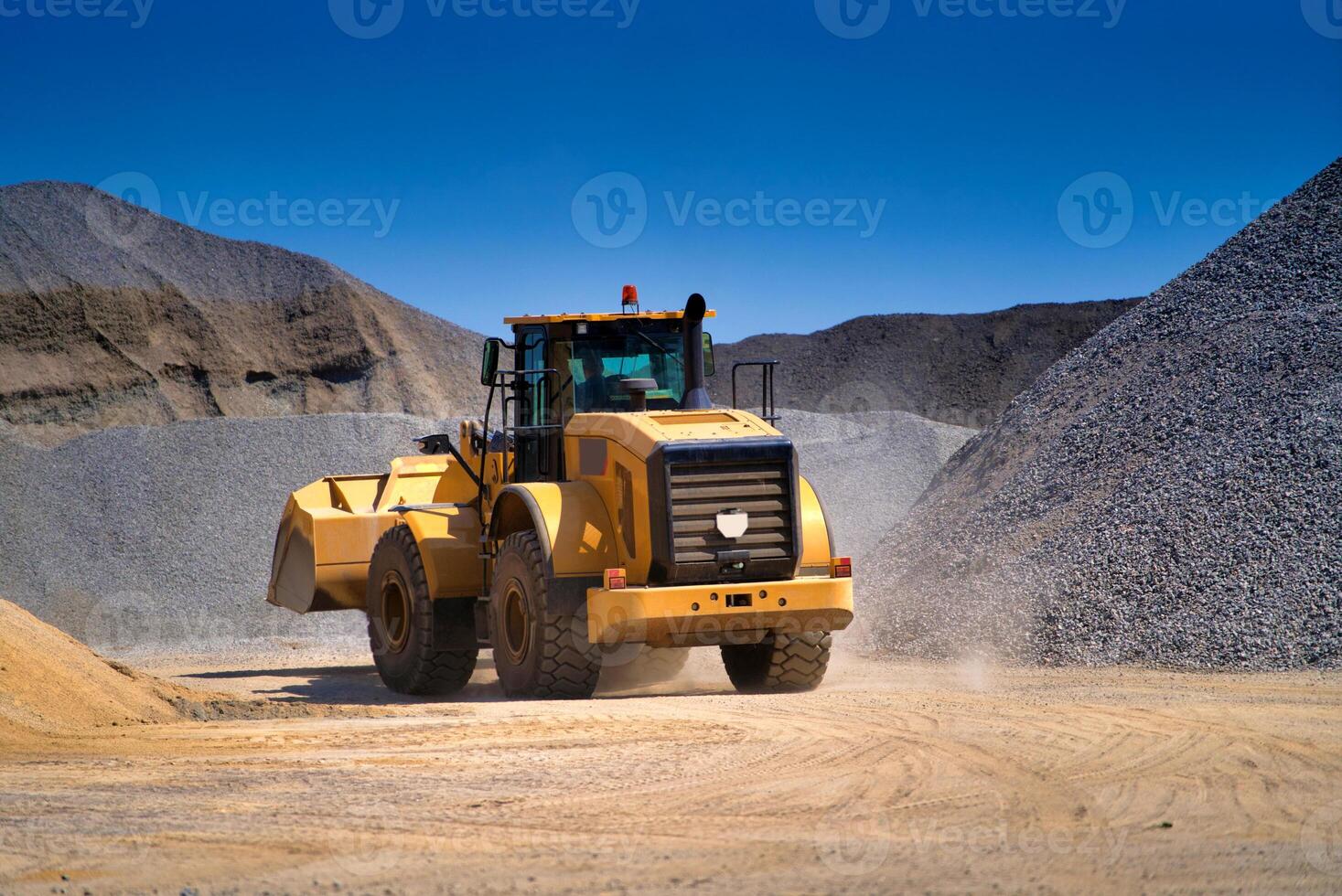 Heavy duty machinery working on highway construction site. Bulldozer, dumper truck, tractor. photo