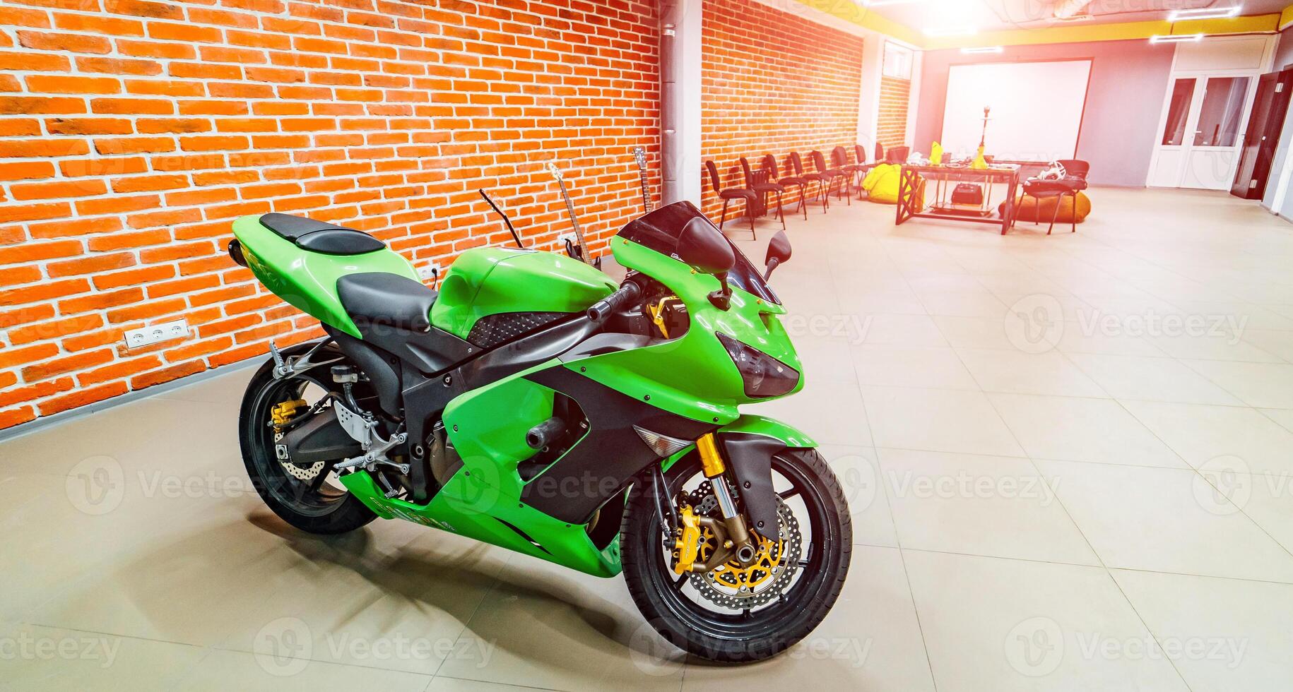 loft style interior with brick walls and green scooter inside. Modern style. Lifestyle concept. Front view. Closeup photo