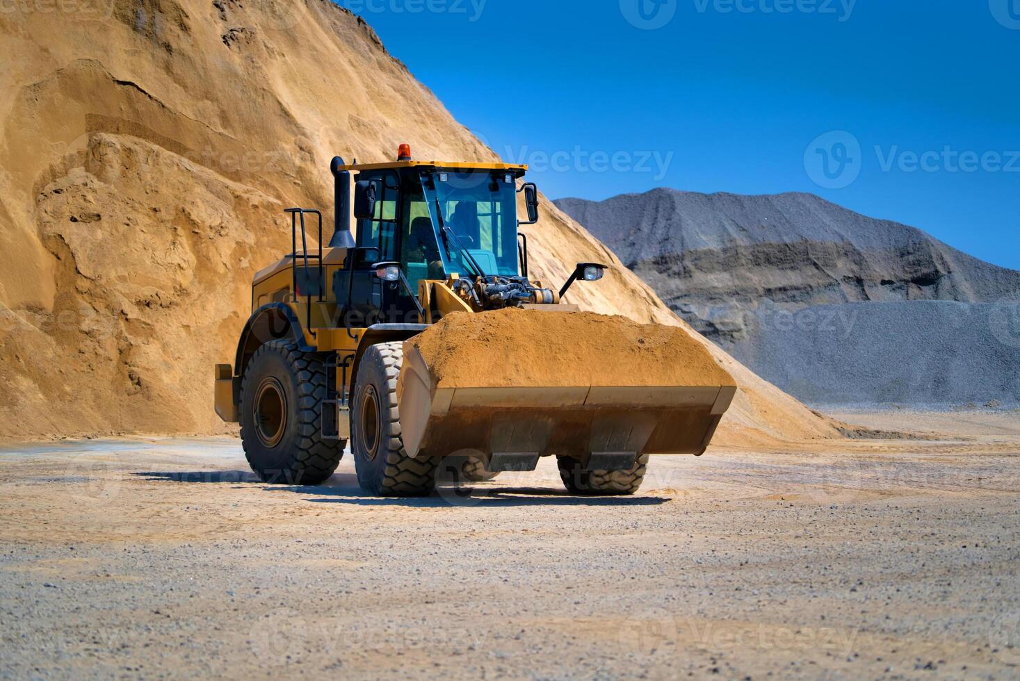 Track-type bulldozer, earth-moving equipment. Land clearing, grading, pool excavation, utility trenching and foundation digging during of large construction jobs. photo