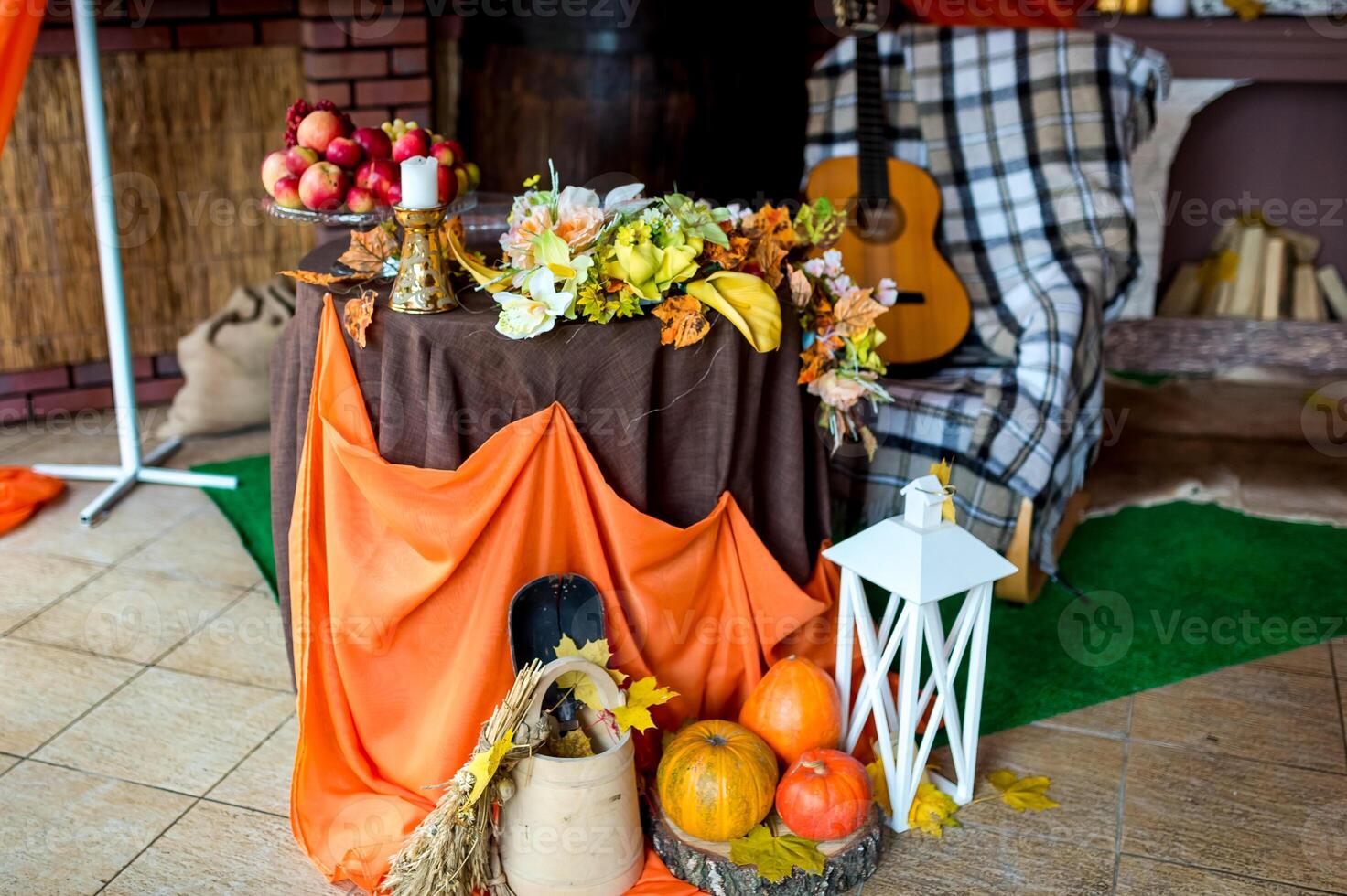 Autumn rural photozone. Beautiful autumn composition with pumpkins and leaves near wooden wall. Guitar, orange cloth and pumpkins. photo