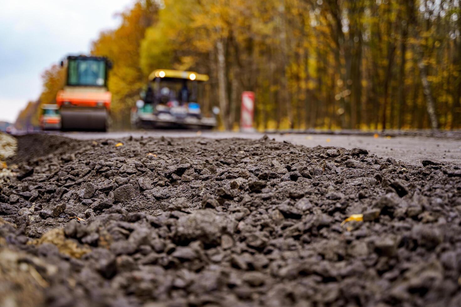Heavy vibration roller at asphalt pavement works. Road repairing. Selective focus. photo