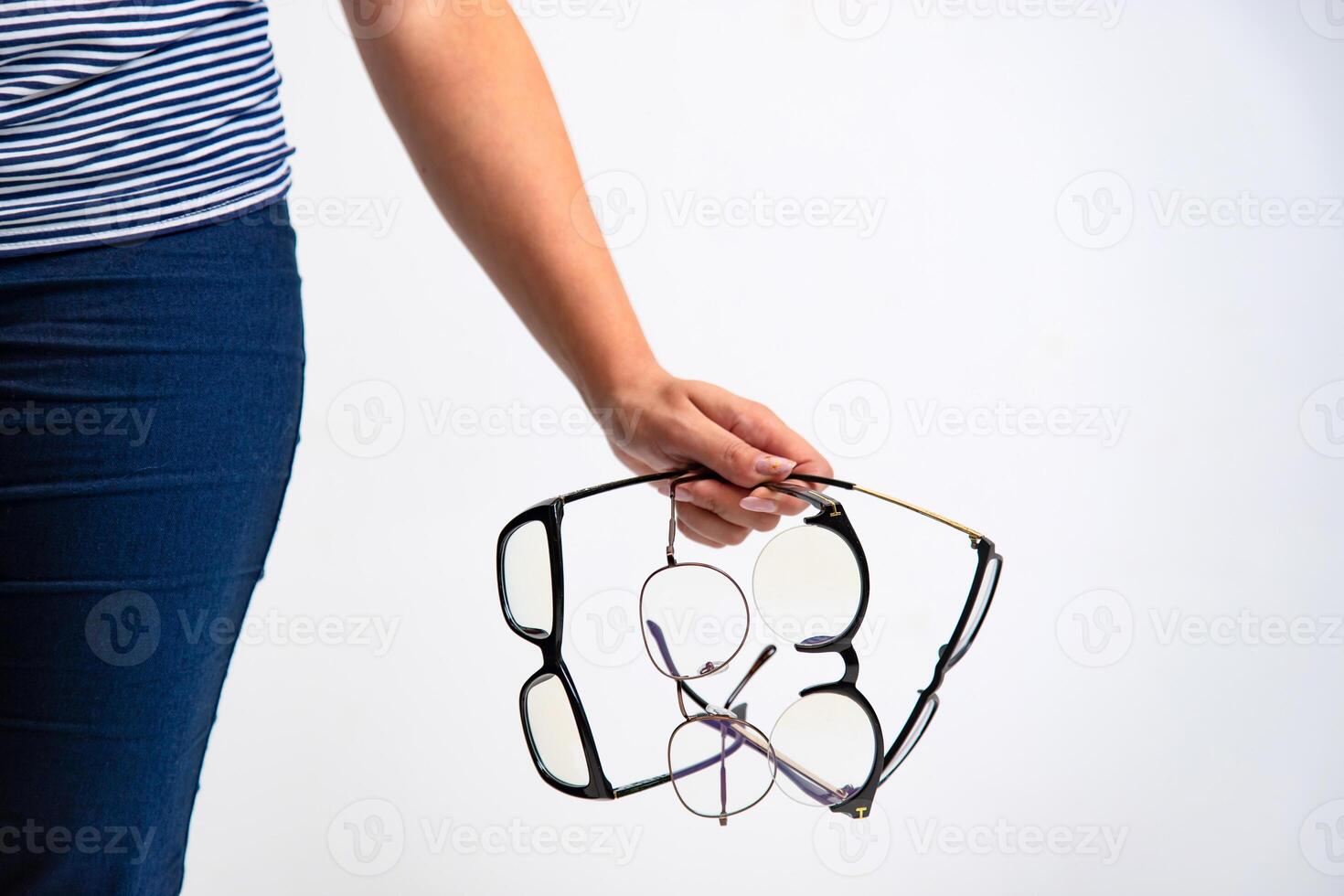 Spectacles closeup. Woman hand holds black framed eyeglasses. photo