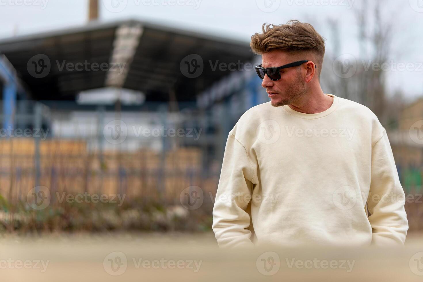 an attractive young man with a white shirt and sunglasses photo