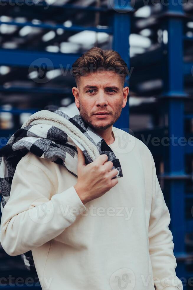 an attractive young man with a white sweater photo