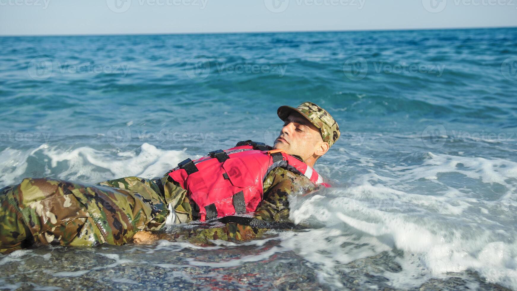 Military man with camouflage and life jacket as safety concept photo