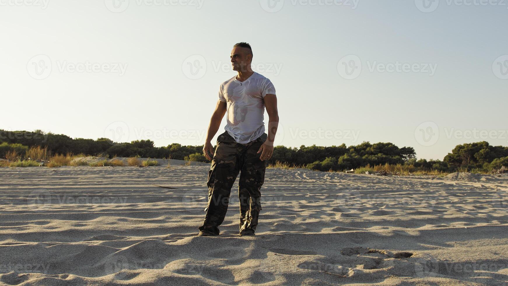 Man on the beach as a concept of freedom and strength photo