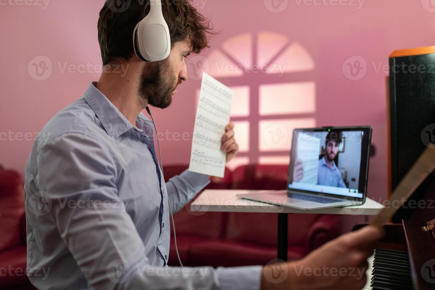 Man Teaching Piano Music Lesson With Remote Video Connection photo