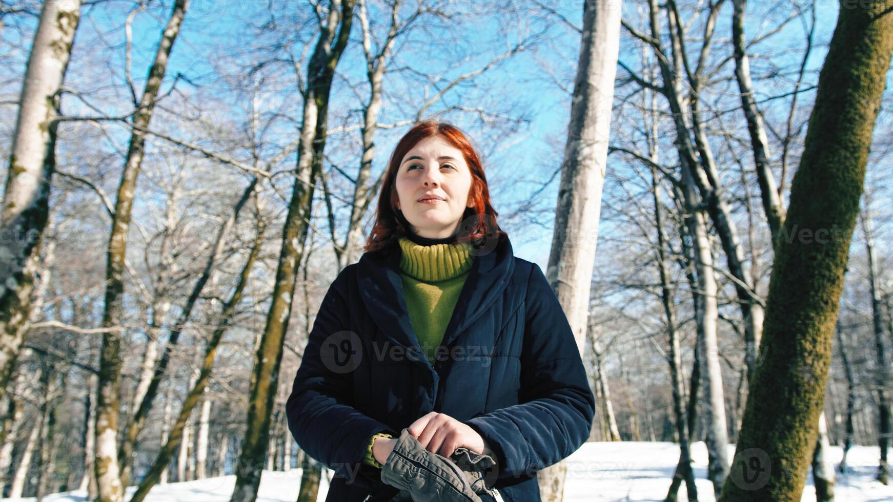 joven niña contento en el Nevado bosque durante invierno foto