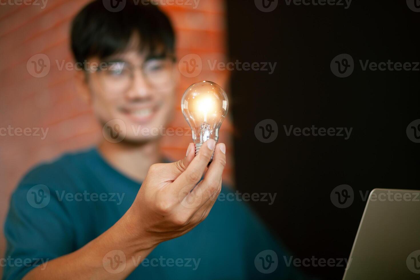 happy handsome young man Succeed at work. Asian businessman working on computer laptop and chatting on smartphone at work. work from home and successful concept photo