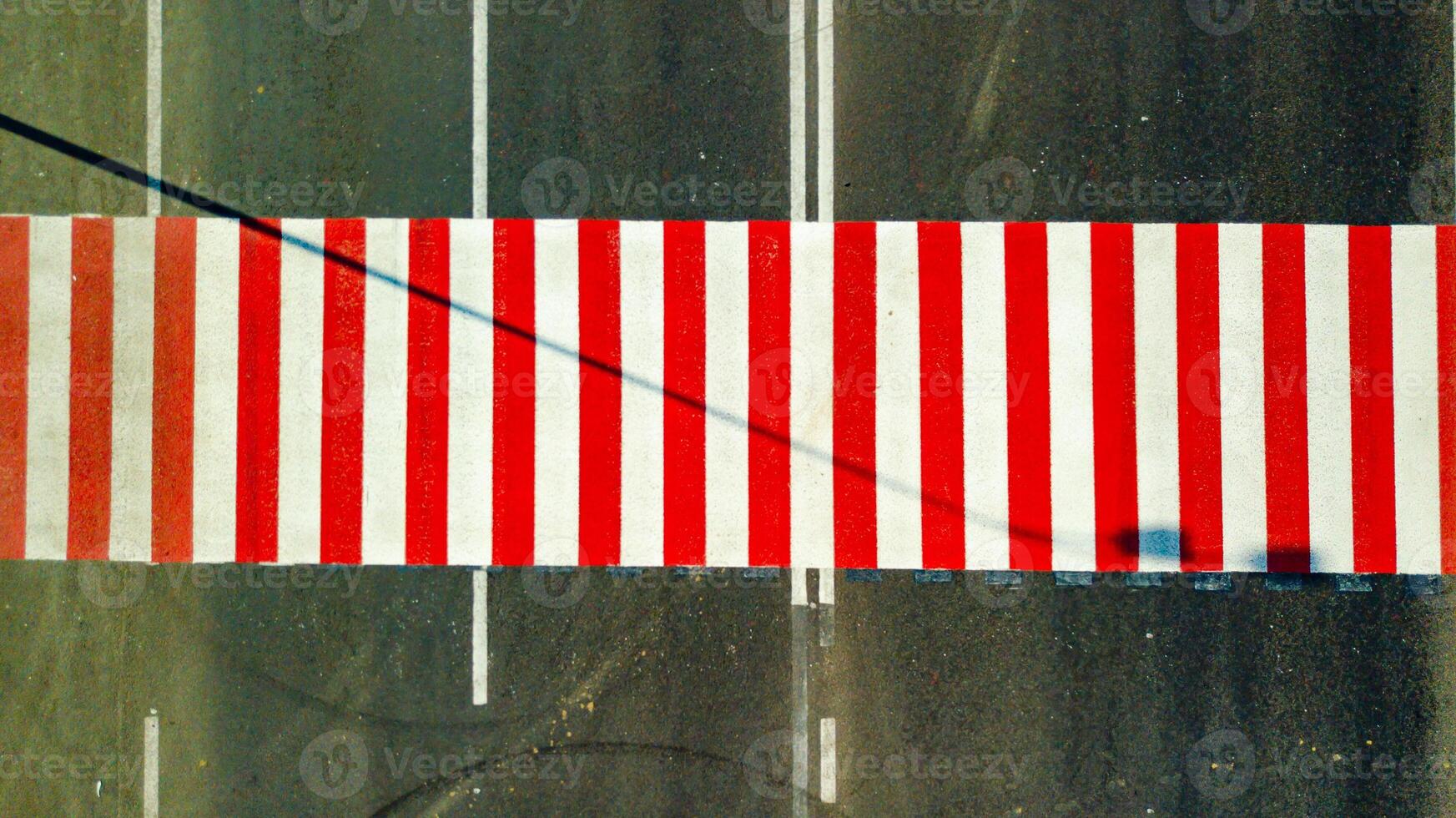 a new red and white colored pedestrian crossing is located on the highway. Aerial view photo