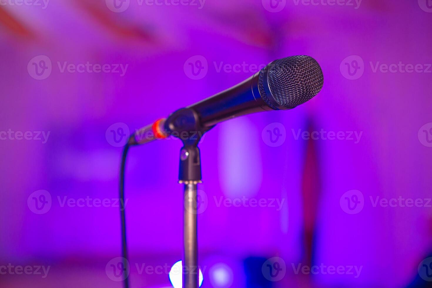Microphone on the blurred background of the audio mixer of the musician. photo
