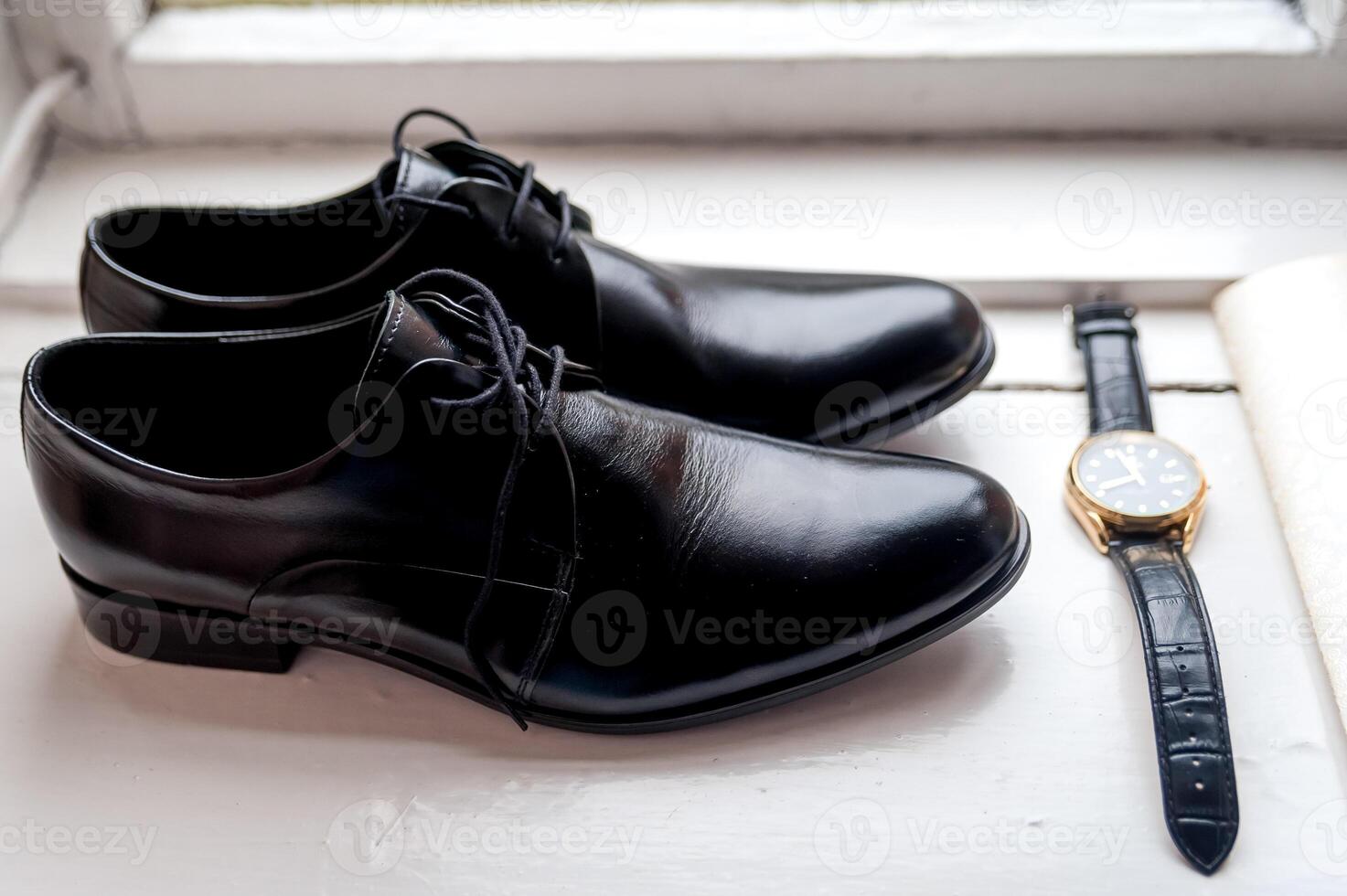 Groom is gathering in the morning. Wedding details. Men's watches and shoes. Leather men's shoes with wathces. Set of groom accessories on wedding day photo