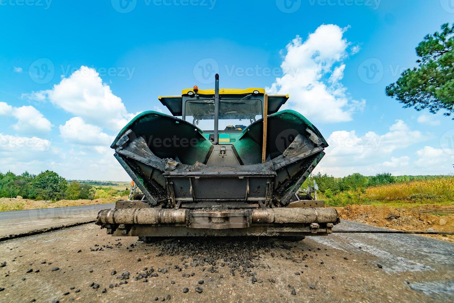 professional machine for leveling soil is on the stones and the background of road at day. Close-up photo