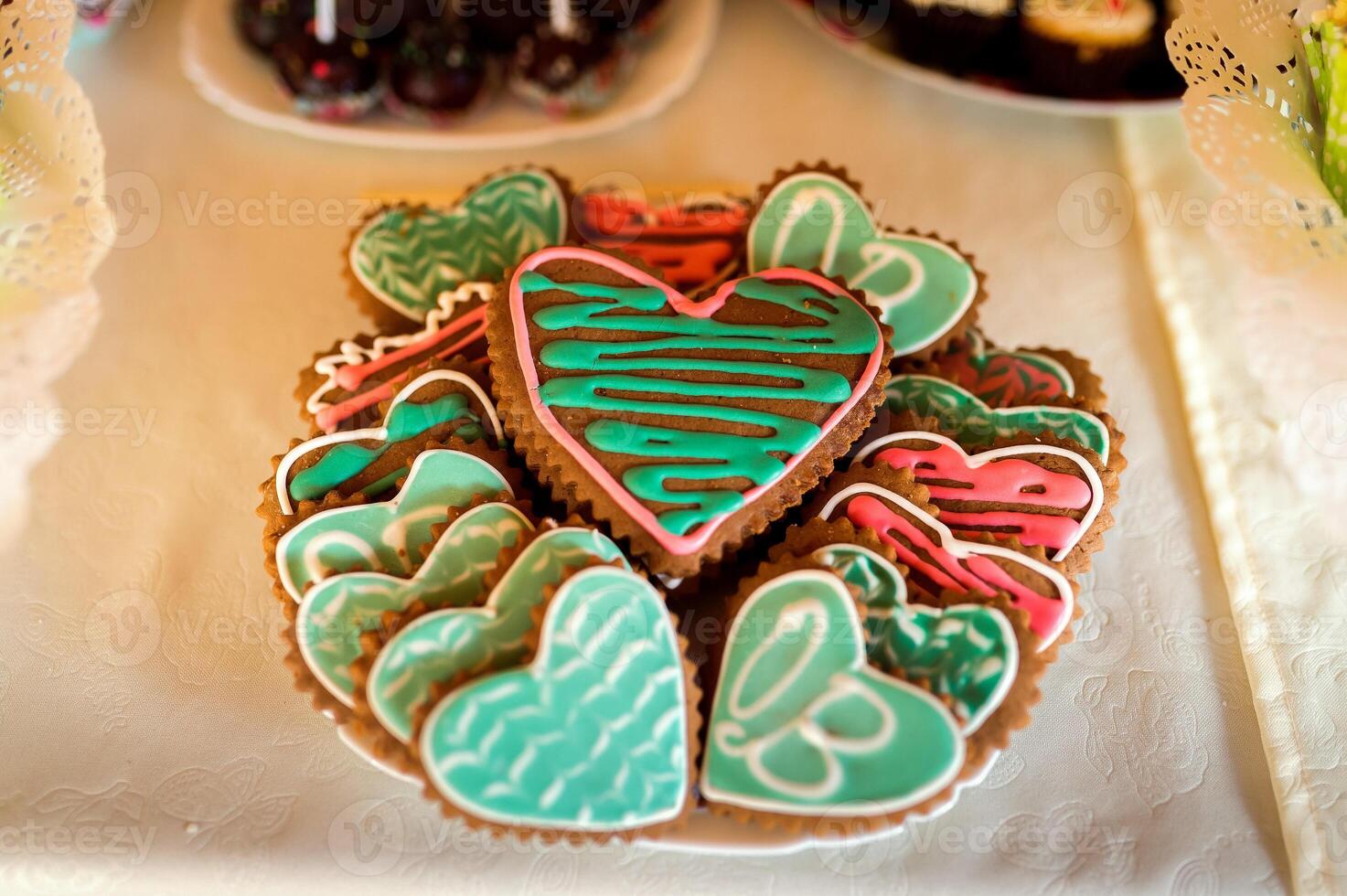 Colorful glazed heart shaped cookies on the table for special day Delicious homemade natural organic pastry, baking with love. photo