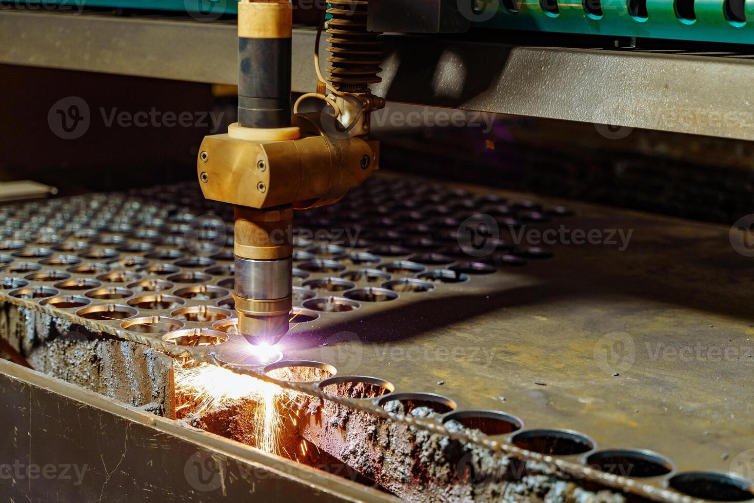 Industrial metal work process. Drilling machine working process on metal factory photo