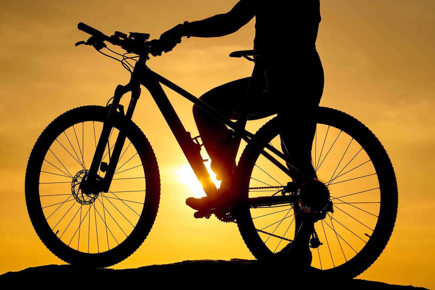 Silhouette of a bike on sky background on sunset. Detailed photo. Closeup photo