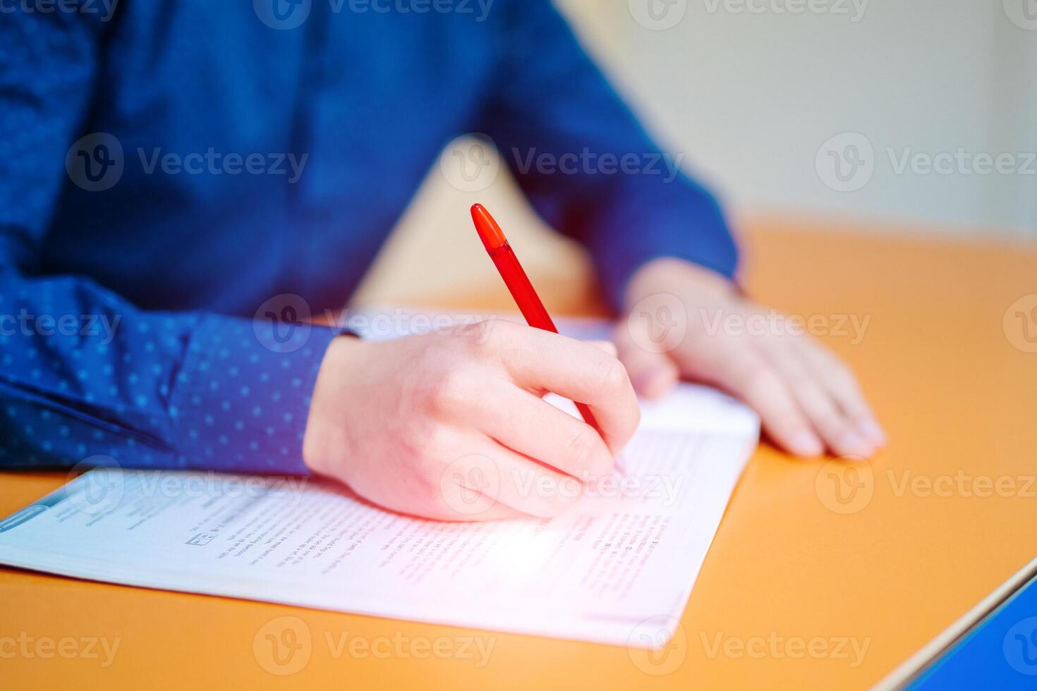 High school or university student writing in lecture class. Examiner testing in examination room. Concept for scholarship to study abroad photo