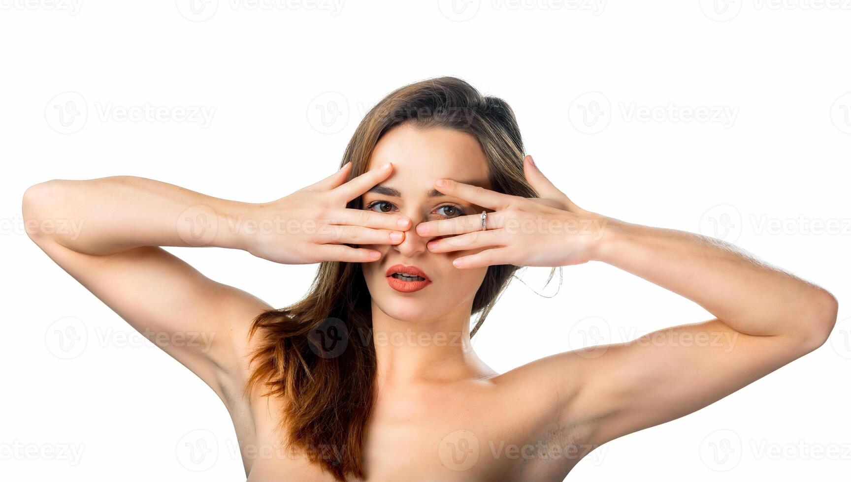 classic beauty portrait of young sexy girl with long hair in front of the camera, looking straight both hands near the face, closeup photo