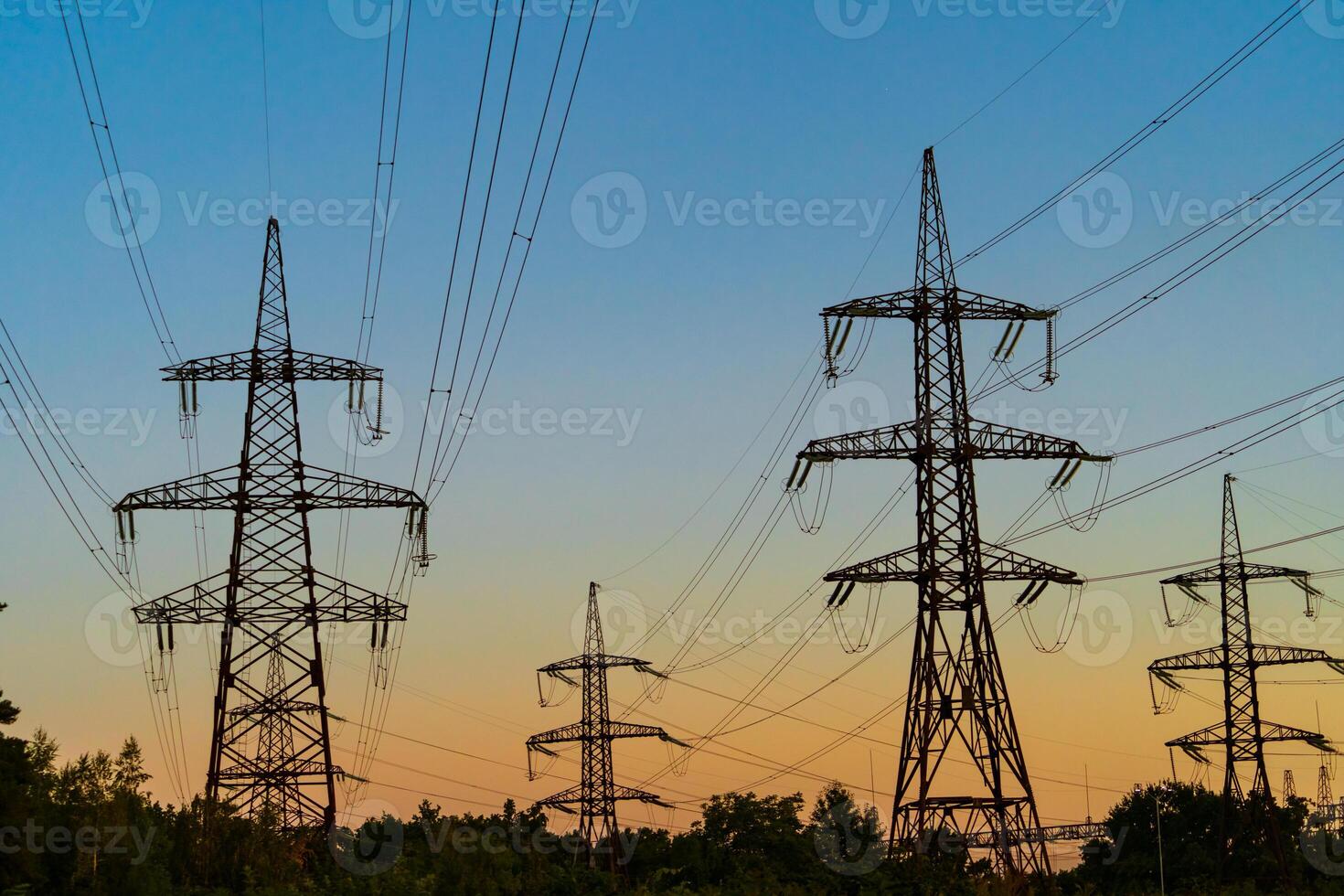 High voltage electric tower Silhouette on sunset time, power pylons on sunset time background. Selective focus photo