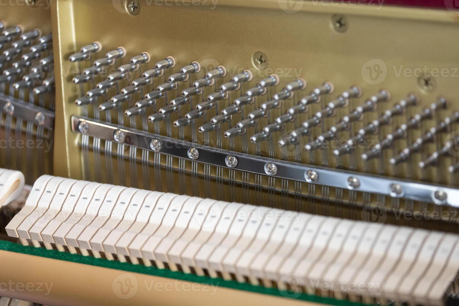 Close-up shallow focus image of the internal mechanisms of an upright piano. It gives a feeling of luxury, beauty, classic, sophistication, elegance. Image can be use for various topics about  music. photo