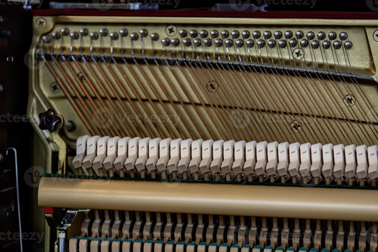 Close-up shallow focus image of the internal mechanisms of an upright piano. It gives a feeling of luxury, beauty, classic, sophistication, elegance. Image can be use for various topics about  music. photo