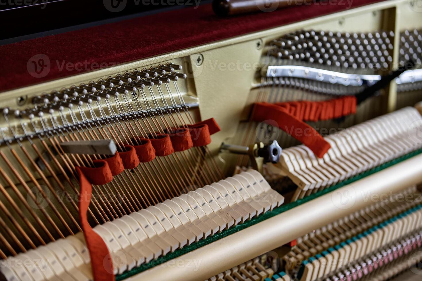 Shallow focus close-up of tools for tuning the internal mechanisms of an upright piano. Gives a feeling of luxury, classic, luxury, grandeur. Pictures can be used on various topics related to music. photo