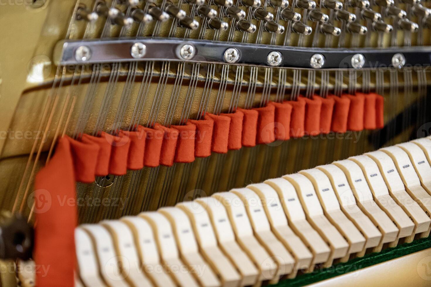 Shallow focus close-up of tools for tuning the internal mechanisms of an upright piano. Gives a feeling of luxury, classic, luxury, grandeur. Pictures can be used on various topics related to music. photo