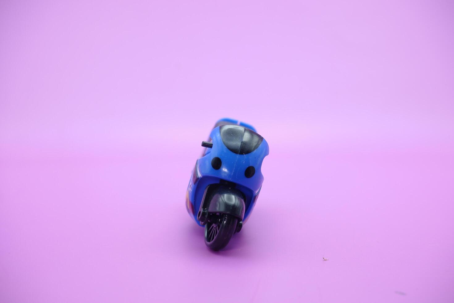 Sports motorbike toy isolated on purple background. mini sports motorbike photo