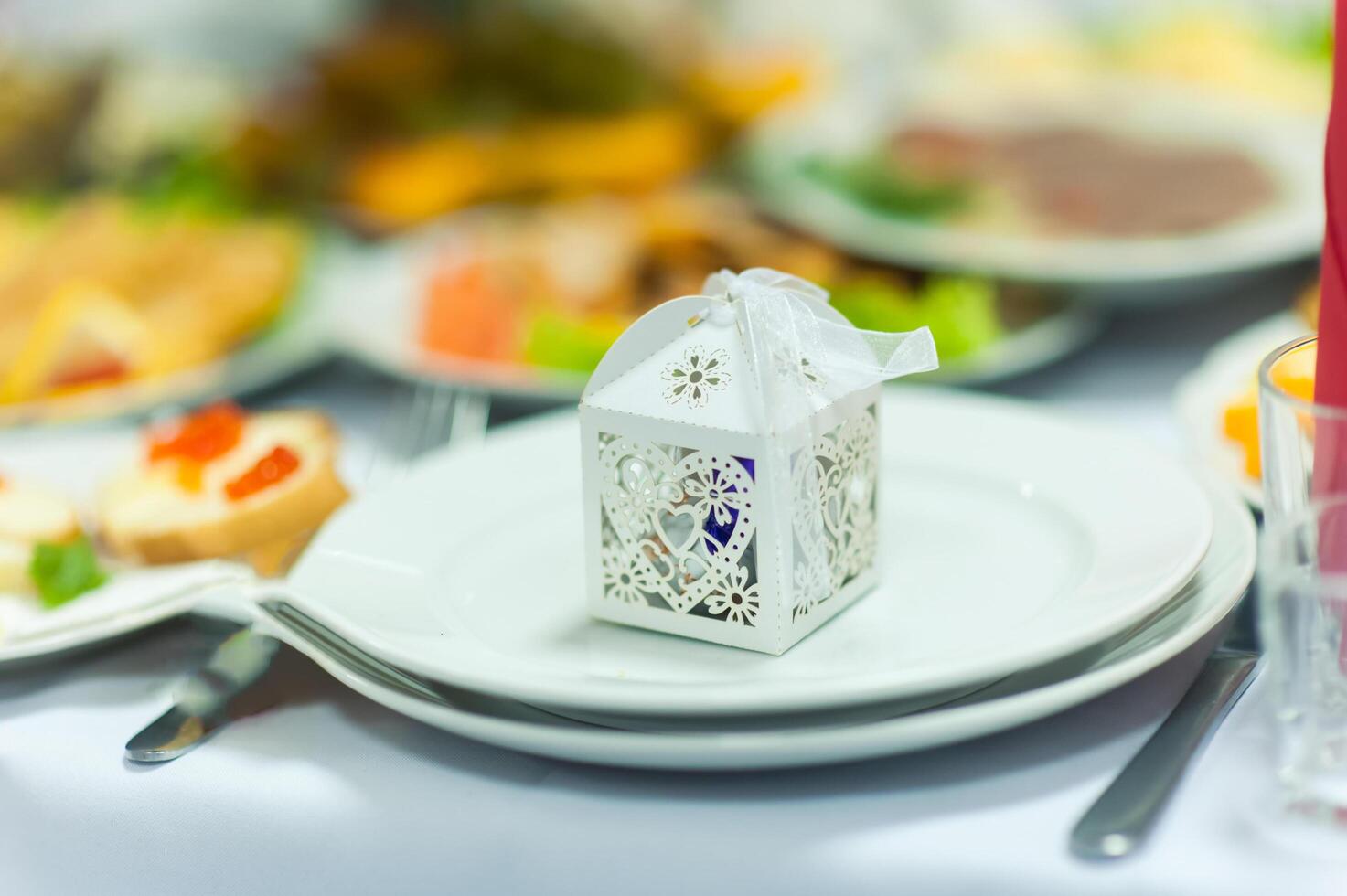 Small wedding box standing on a plate. Happy bithday surprise. photo