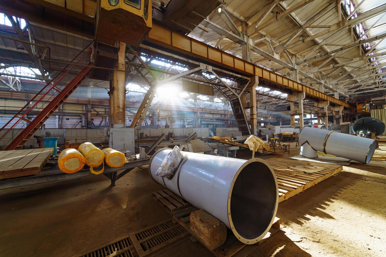 Large industrial factory equipment with stainless tubes. Engineering warehouse indoors and some tubes in it. photo