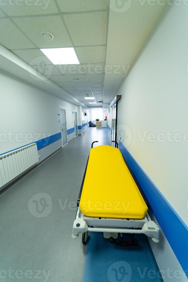 Healthcare clinical bed standing in corridor. Medical modern inerior of corridor in hospital. photo