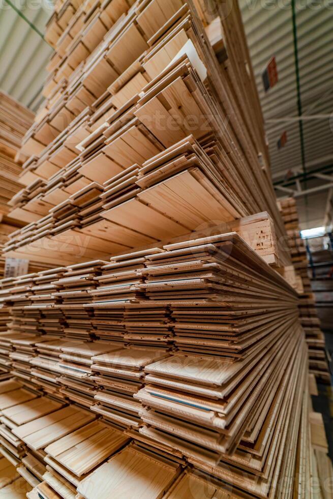high racks with a parquet board are in the warehouse of plant. Manufacturing of a parquet board. Close-up photo