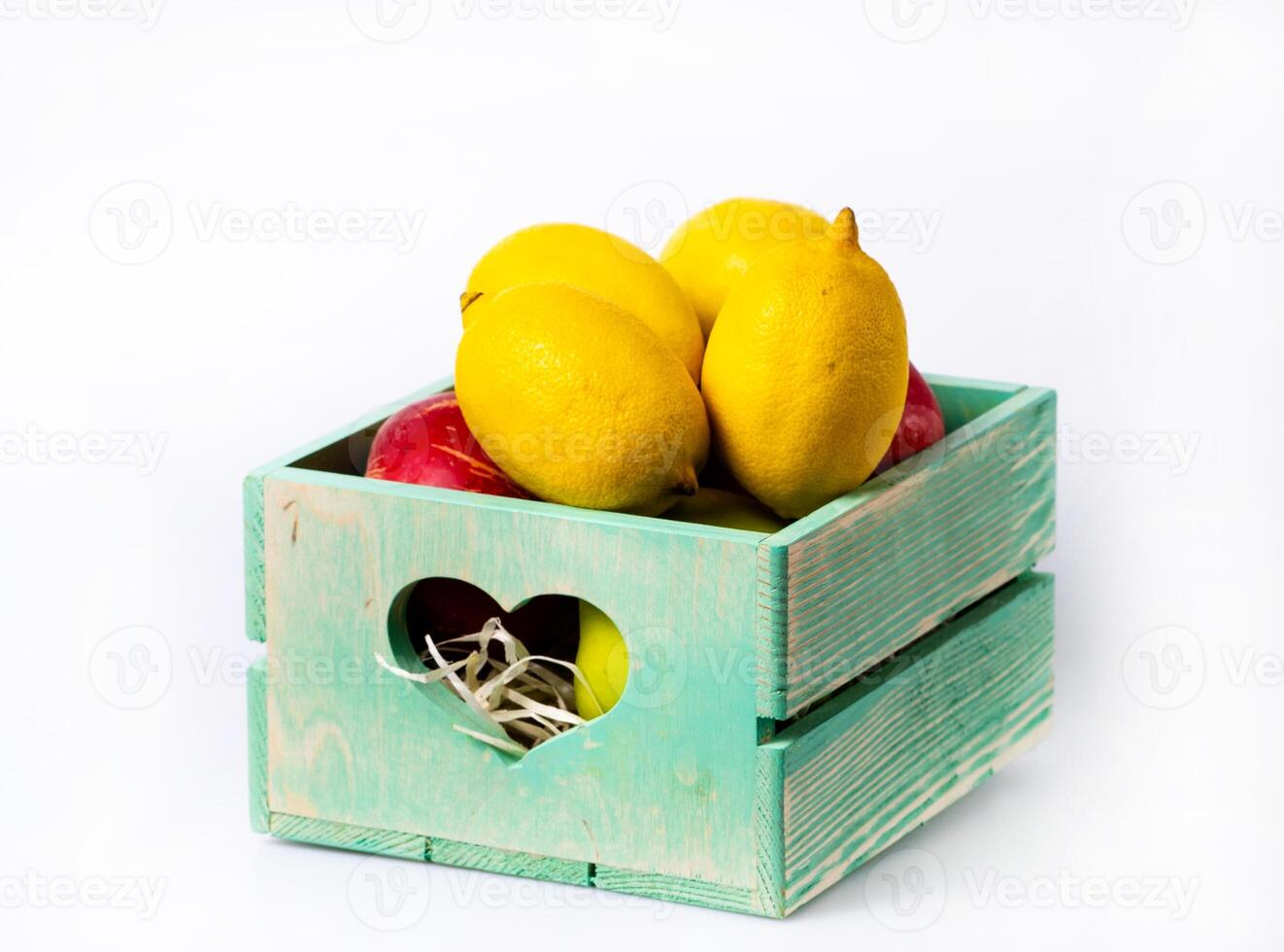 ripe lemon in wooden box on white background photo