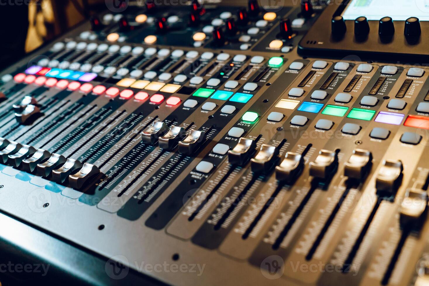 Professional audio mixing console with faders and adjusting knobs,TV equipment. The DJ is adjusting the volume of the sound. photo