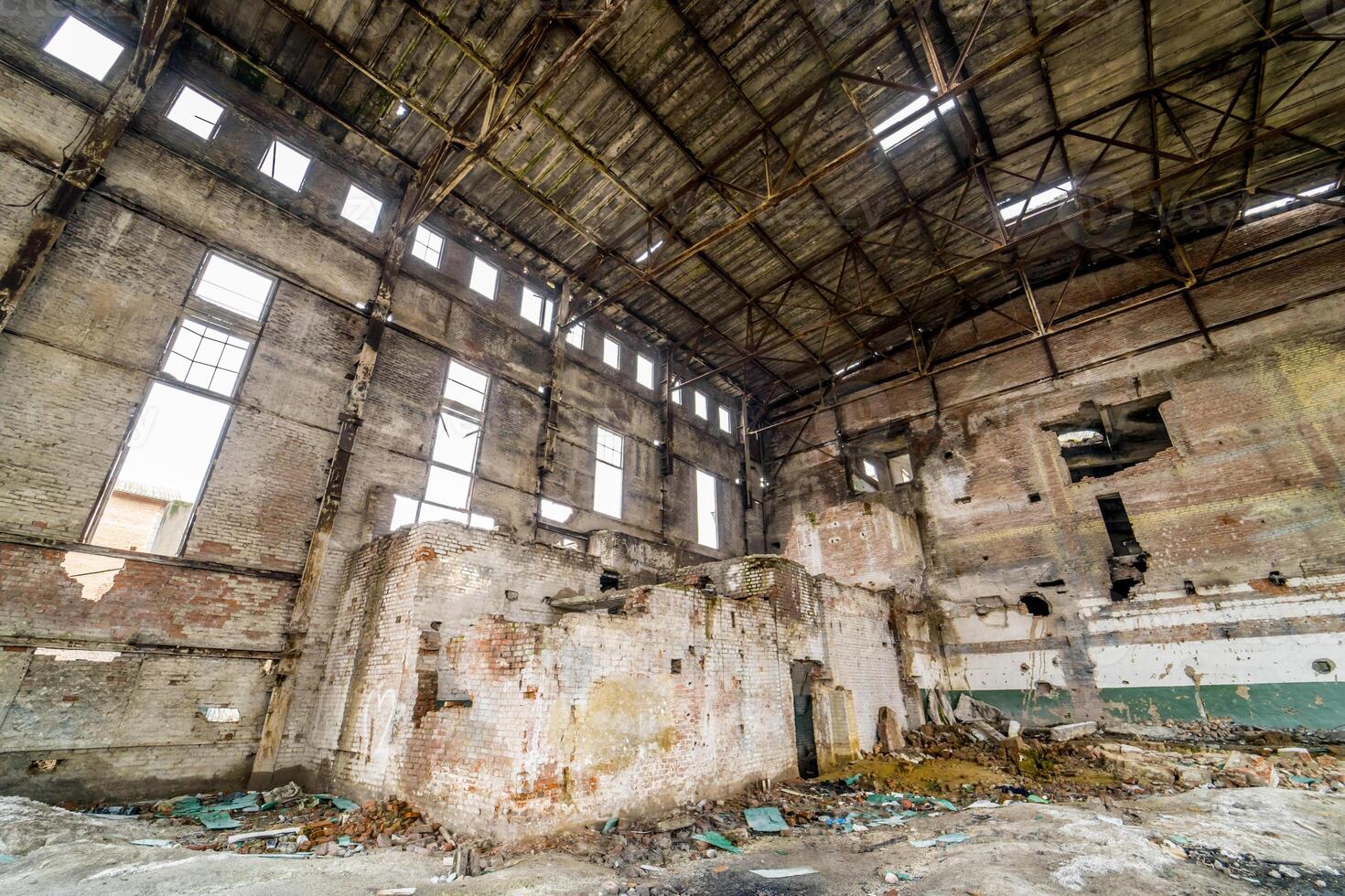 Industrial buildings in abandoned factory . Abandoned industrial interior with bright light photo
