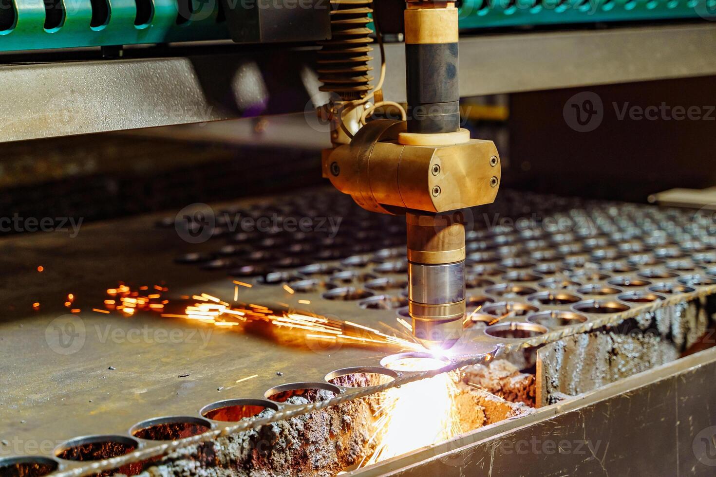 Cutting of sheet metal process in factory. Production CNC laser cutting metal sheet with bright sparkle in factory. Close-up photo