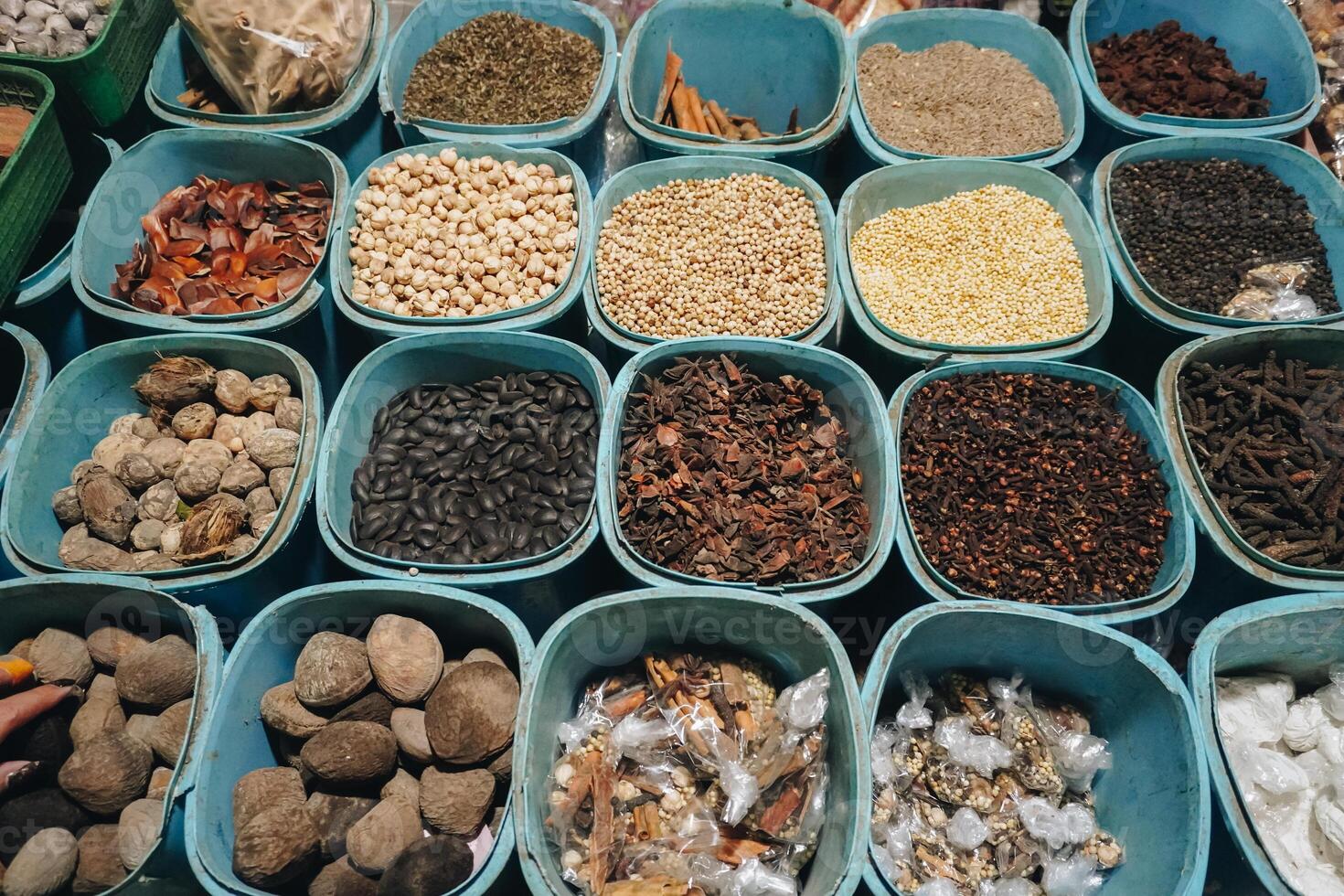 A closeup view of many types of herbs, placed on tray with square and rectangle shape. Traditional Indonesian medicine concept photo