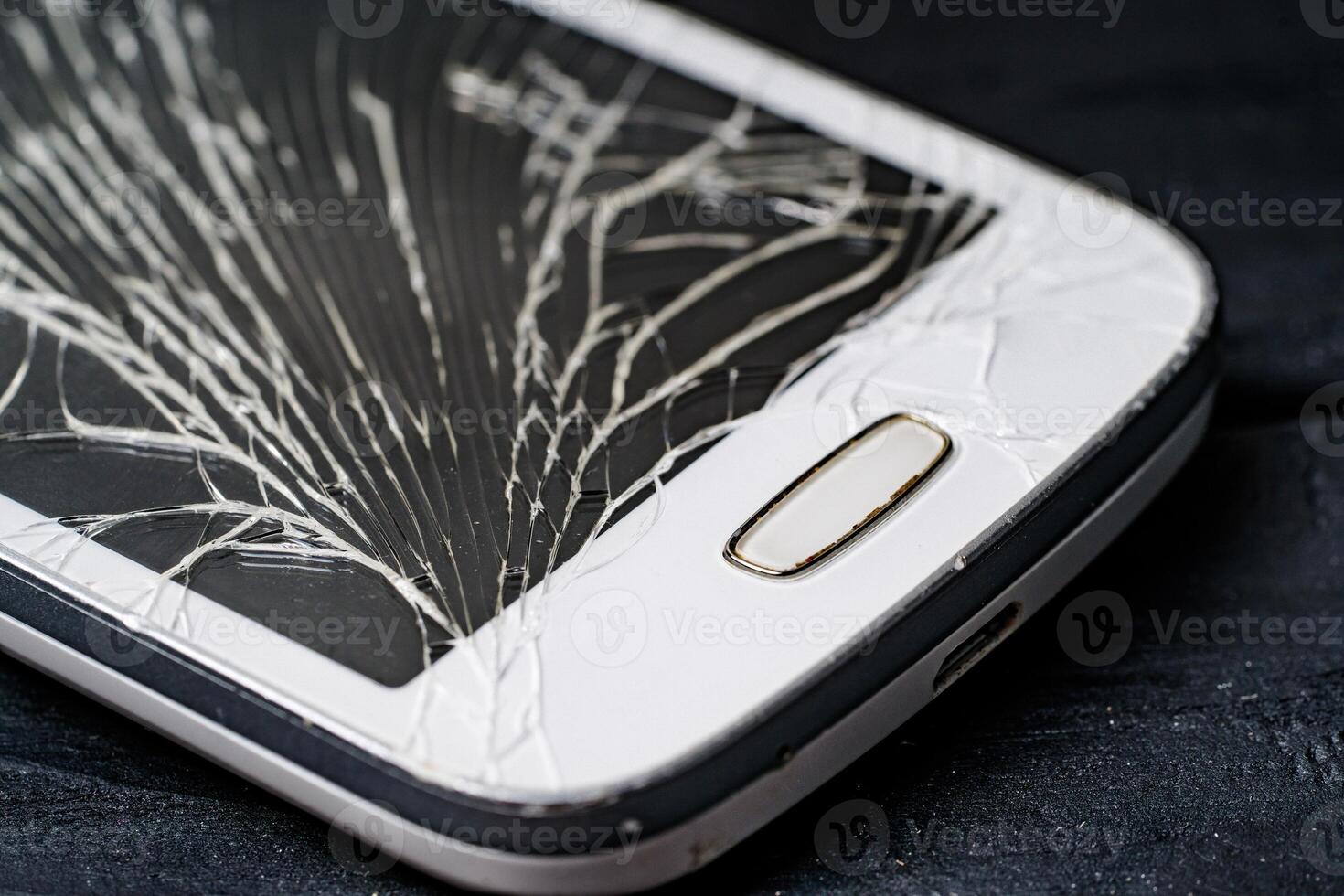 Broken phone on black background. Phone repair advertisement. Broken screen in smartphone photo