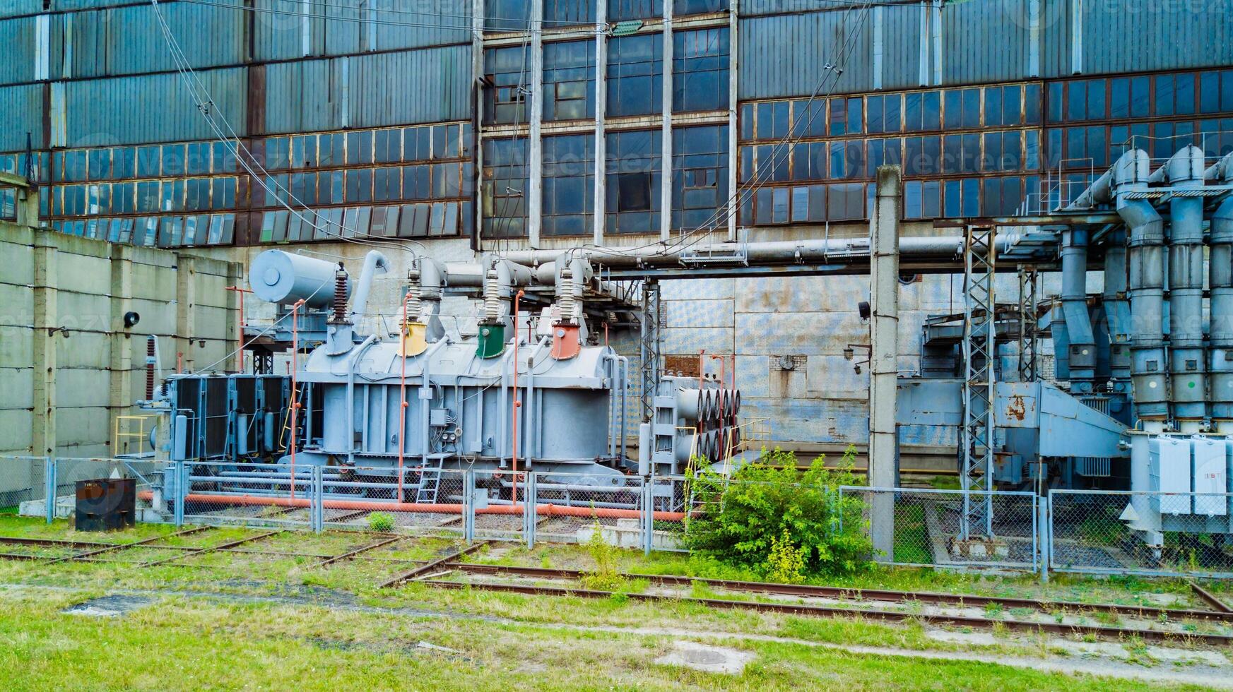 parte de un antiguo eléctrico poder planta afuera. trasero de un grande poder planta en verano. foto