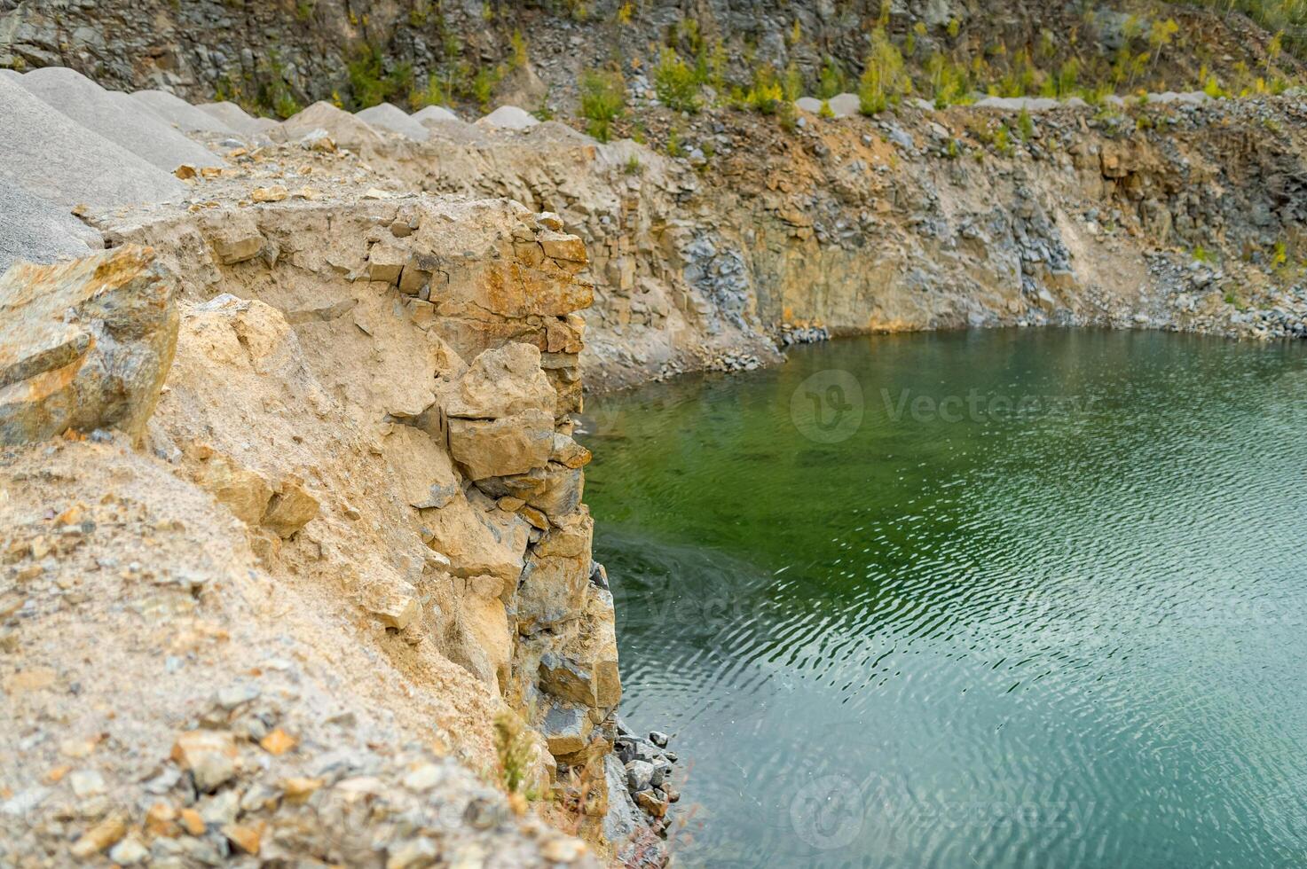 flooded pit mining or quarry with beautiful blue water. Side view panoramic photo. photo