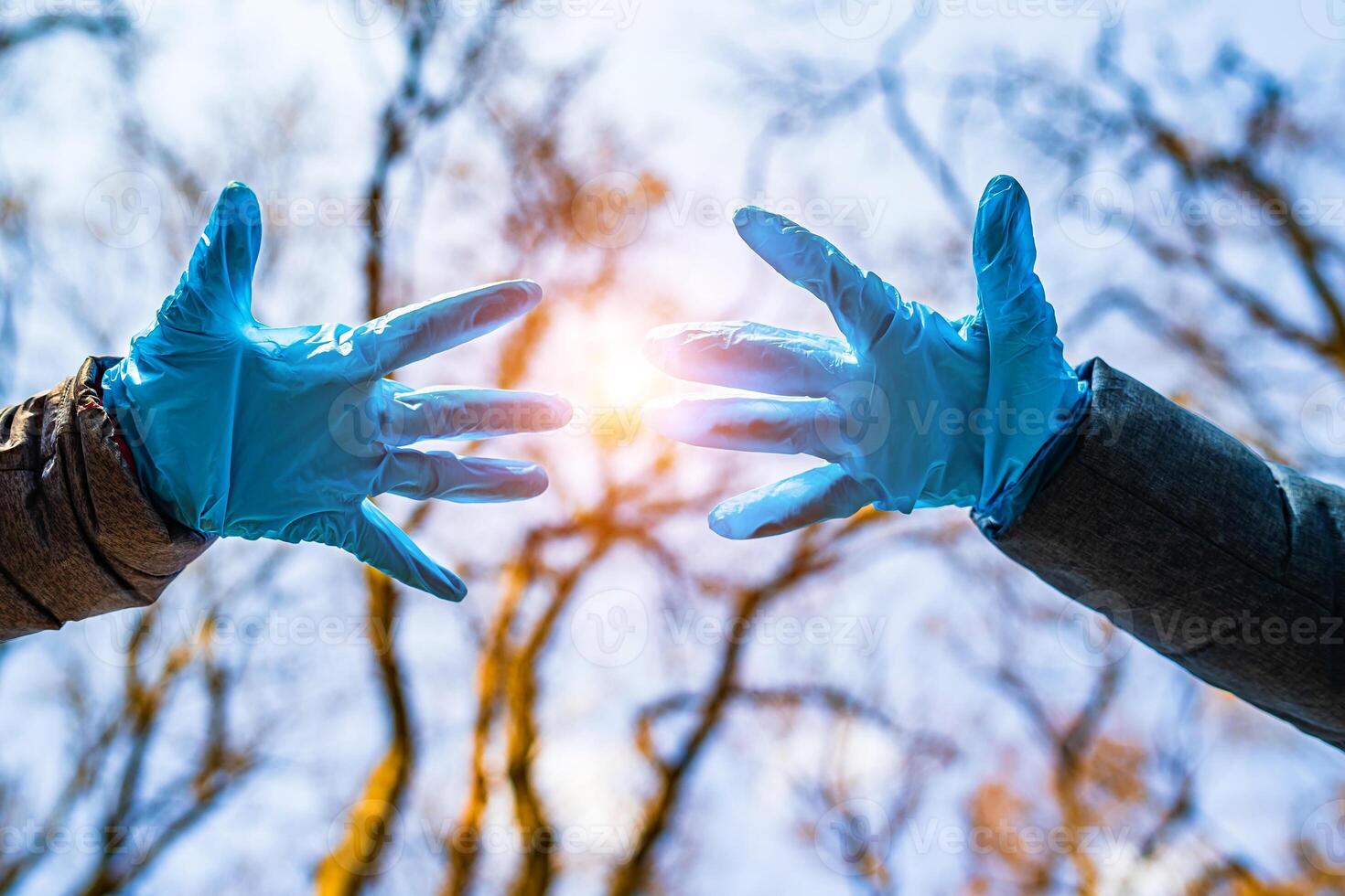 Hands in blue medical gloves on the street avoid the spread of coronavirus. Pandemic Covid-19. Stop coronavirus photo