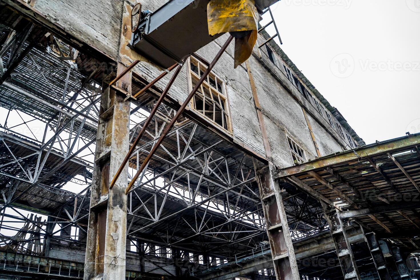 Old destroyed abandoned factory. Ruins of very heavily polluted industrial factory photo