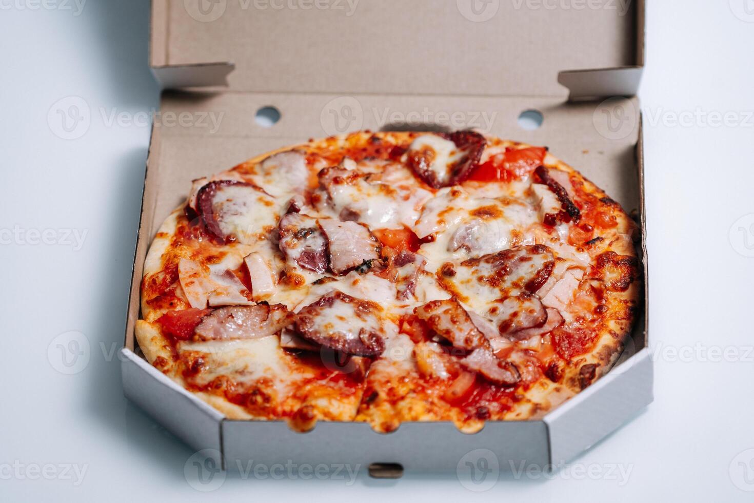 Traditional italian pizza in cardboard box. photo