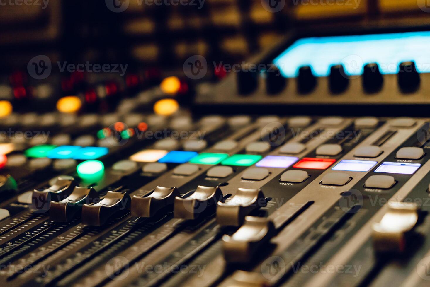 a professional concert mixing console with faders is used by a DJ for recording music. Close-up photo