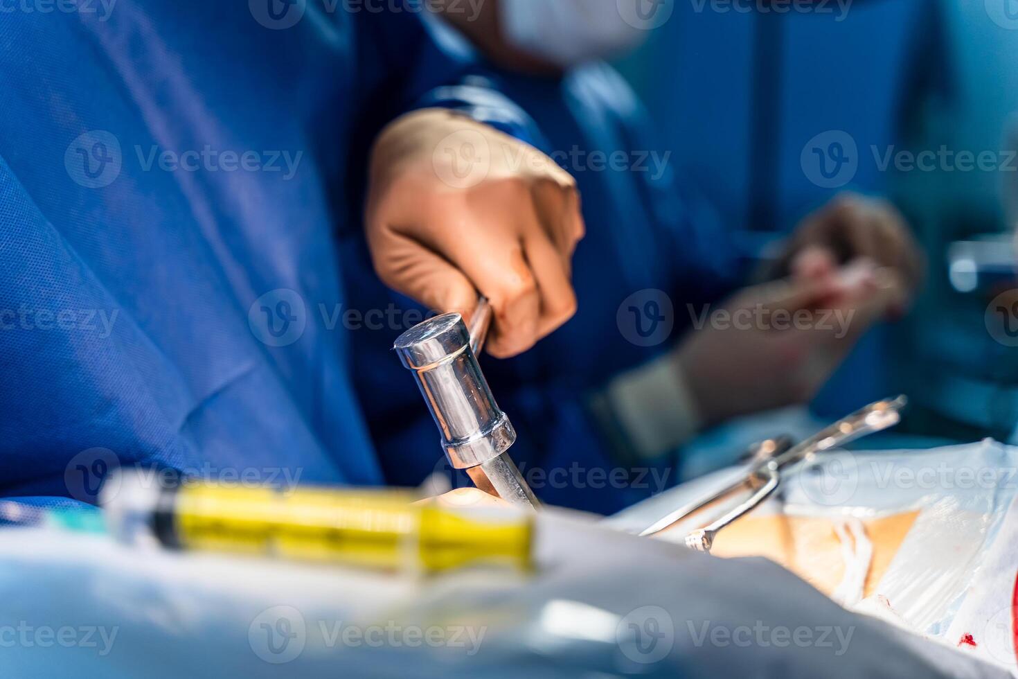 Operating room with surgery in progress. Medical team performing surgical operation in bright modern operating room photo