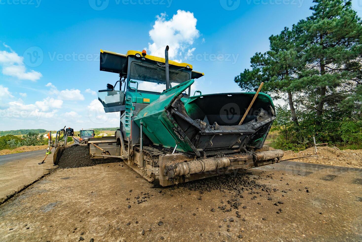 professional technique for leveling the ground is on the roadside in the summer near the trees. Close-up photo