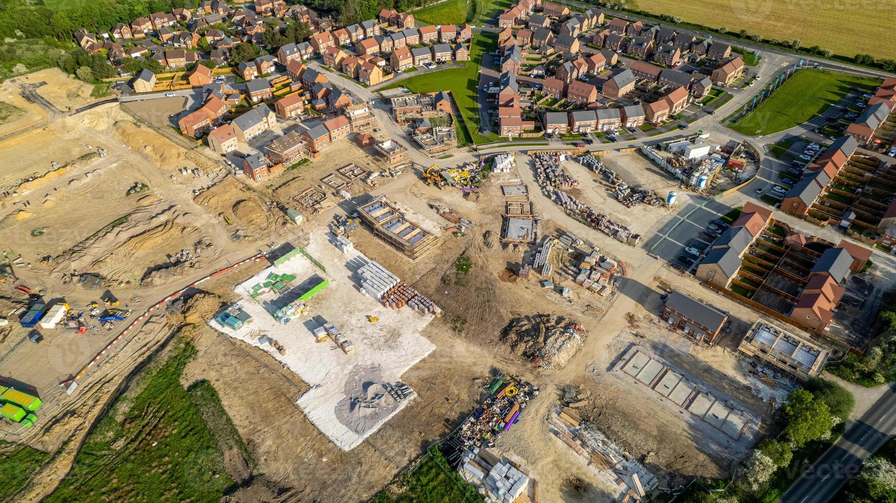 Aerial view of a residential construction site with partially completed houses and infrastructure. photo